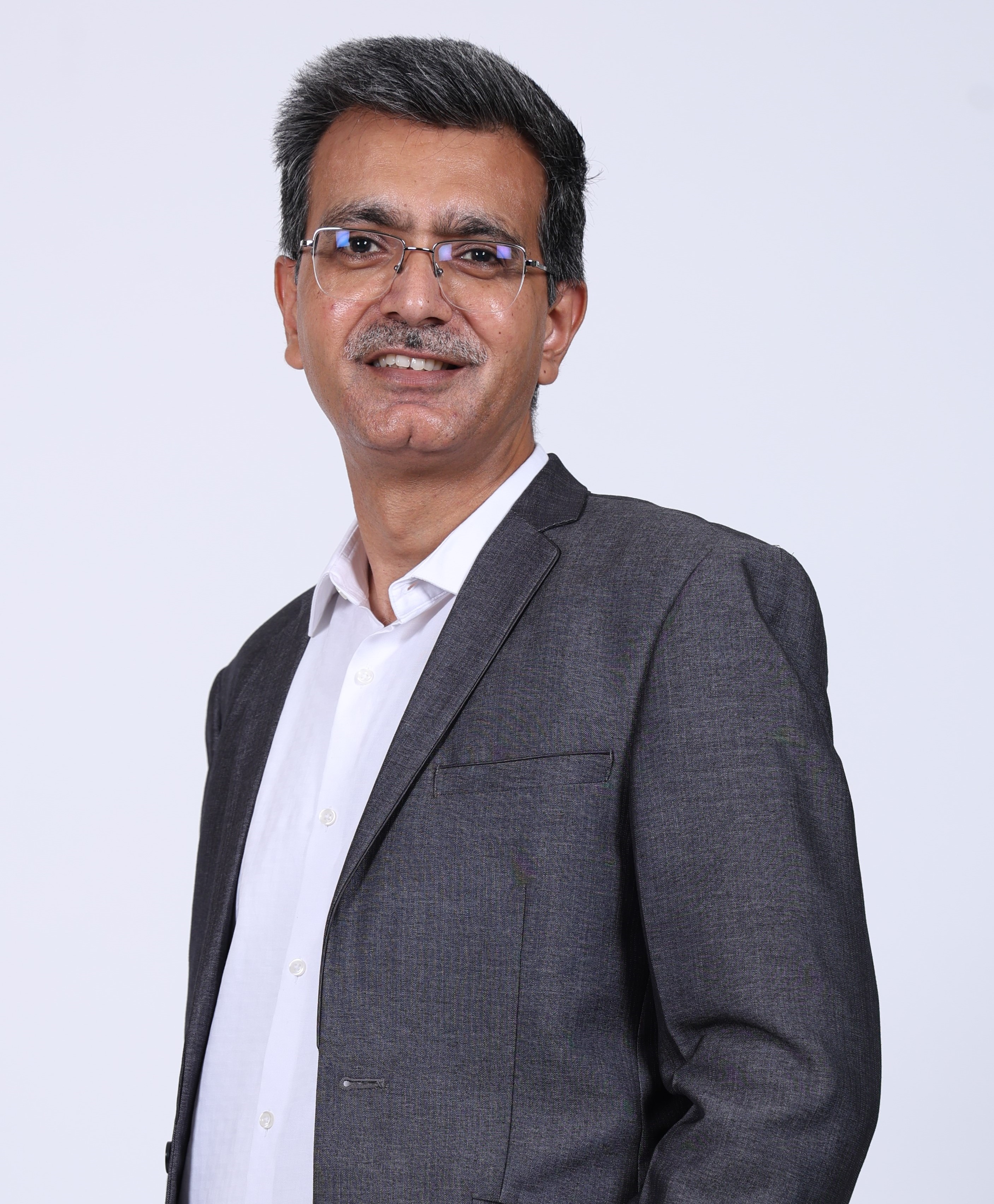 Vinod_Mehta CHRO of Teleperformance seen in white color shirt and grey color suit